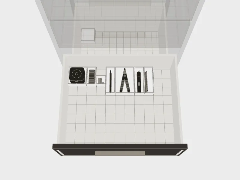 A drawer from above, each thing in a tray shaped for it.